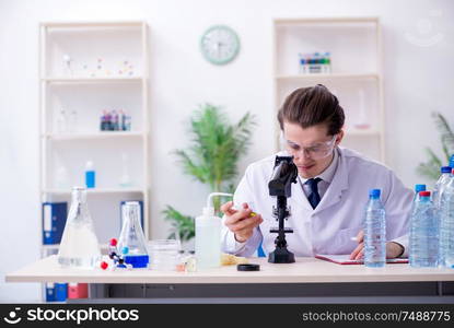 The young male chemist experimenting in lab. Young male chemist experimenting in lab