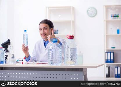 The young male chemist experimenting in lab. Young male chemist experimenting in lab