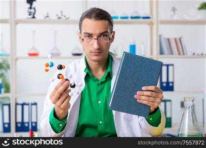 The young male chemist teacher in the lab. Young male chemist teacher in the lab