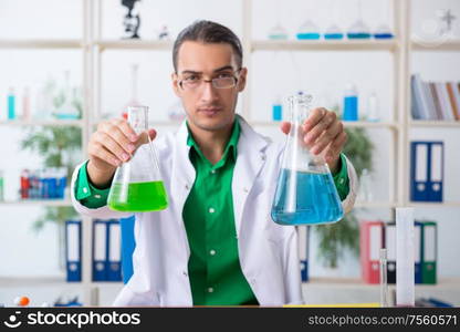 The young male chemist teacher in the lab. Young male chemist teacher in the lab