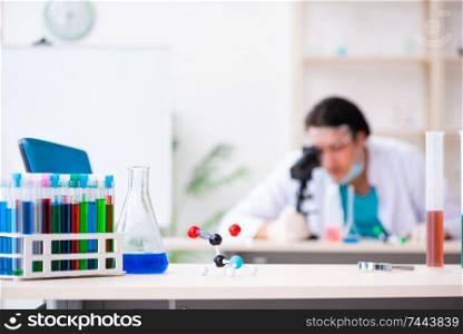 The young male chemist working in the lab . Young male chemist working in the lab 