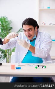 The young male chemist working in the lab. Young male chemist working in the lab