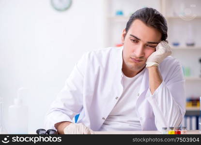 The young male chemist working in the lab. Young male chemist working in the lab