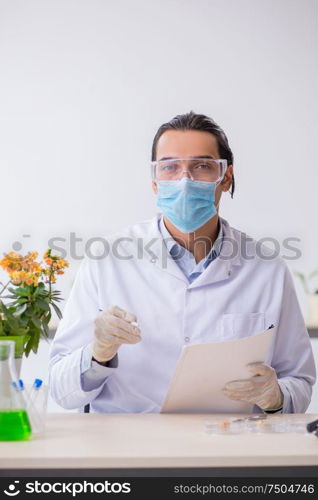 The young male chemist working in the lab. Young male chemist working in the lab