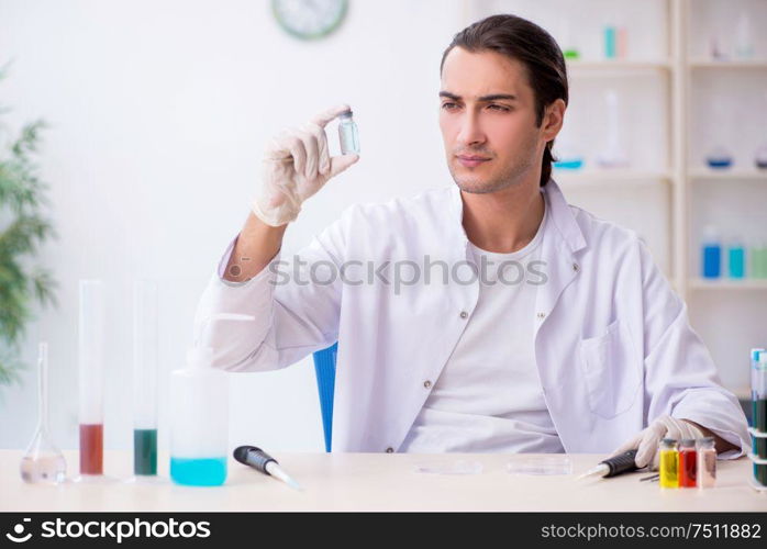 The young male chemist working in the lab. Young male chemist working in the lab