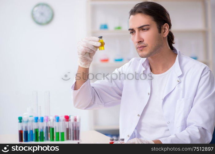 The young male chemist working in the lab. Young male chemist working in the lab