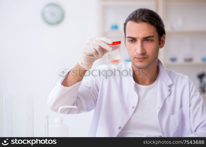 The young male chemist working in the lab. Young male chemist working in the lab