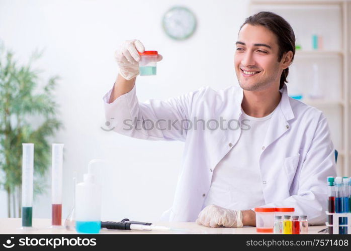 The young male chemist working in the lab. Young male chemist working in the lab