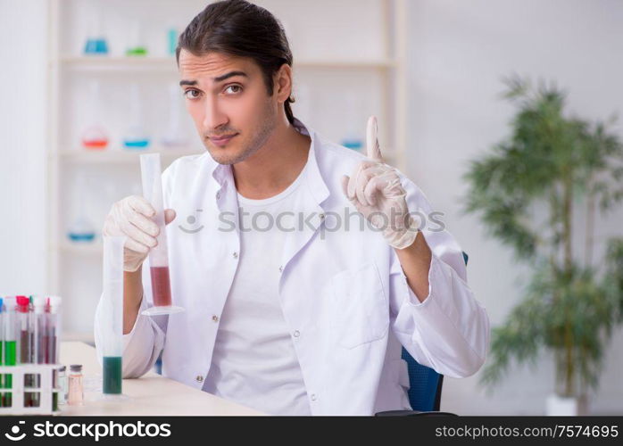 The young male chemist working in the lab. Young male chemist working in the lab