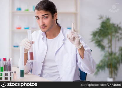 The young male chemist working in the lab. Young male chemist working in the lab