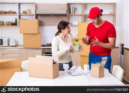 The young male contractor and female customer in moving concept  . Young male contractor and female customer in moving concept  