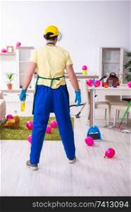 The young male contractor doing housework after party . Young male contractor doing housework after party 