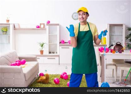 The young male contractor doing housework after party . Young male contractor doing housework after party 