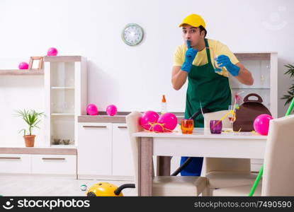 The young male contractor doing housework after party. Young male contractor doing housework after party