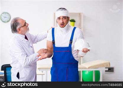 The young male contractor visiting old doctor . Young male contractor visiting old doctor