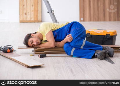 The young male contractor working indoors. Young male contractor working indoors