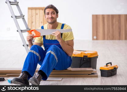 The young male contractor working indoors. Young male contractor working indoors