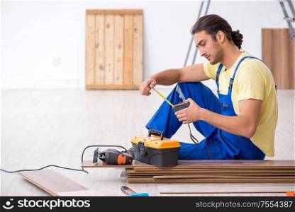 The young male contractor working indoors. Young male contractor working indoors