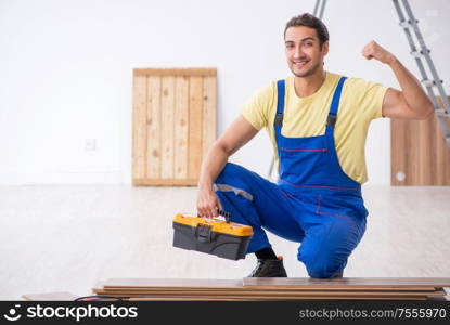 The young male contractor working indoors. Young male contractor working indoors