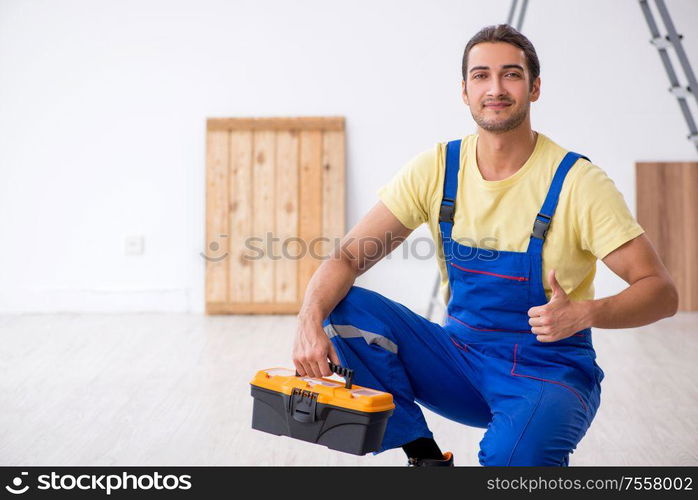 The young male contractor working indoors. Young male contractor working indoors