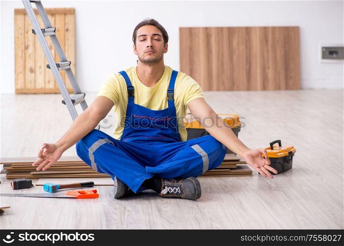 The young male contractor working indoors. Young male contractor working indoors