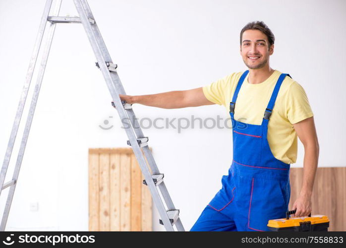 The young male contractor working indoors. Young male contractor working indoors