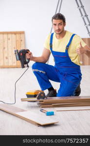 The young male contractor working indoors. Young male contractor working indoors