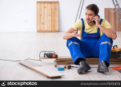 The young male contractor working indoors. Young male contractor working indoors