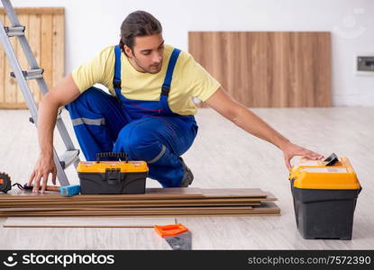 The young male contractor working indoors. Young male contractor working indoors