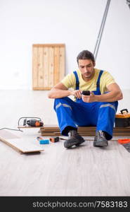 The young male contractor working indoors. Young male contractor working indoors