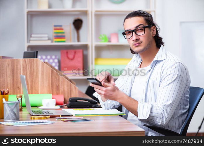 The young male designer working in the office . Young male designer working in the office