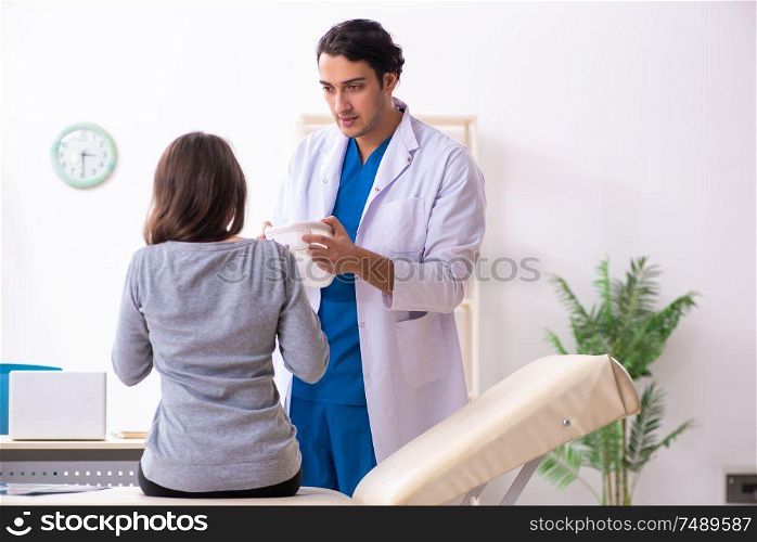 The young male doctor and female beautiful patient . Young male doctor and female beautiful patient