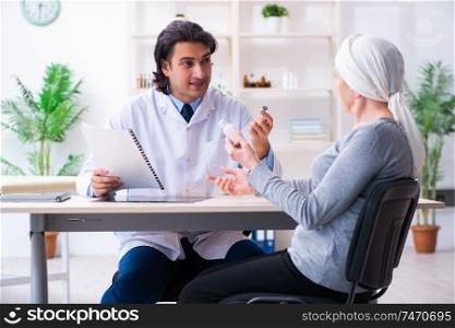 The young male doctor and female oncology patient . Young male doctor and female oncology patient 
