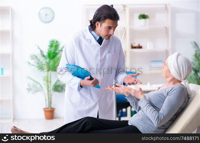 The young male doctor and female oncology patient . Young male doctor and female oncology patient