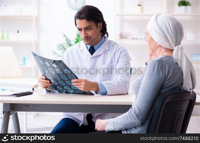 The young male doctor and female oncology patient . Young male doctor and female oncology patient