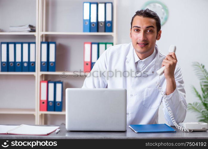 The young male doctor at the reception in the hospital. Young male doctor at the reception in the hospital