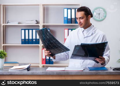 The young male doctor at the reception in the hospital. Young male doctor at the reception in the hospital