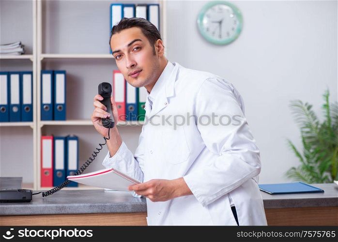The young male doctor at the reception in the hospital. Young male doctor at the reception in the hospital