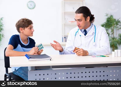 The young male doctor examining boy in the clinic. Young male doctor examining boy in the clinic