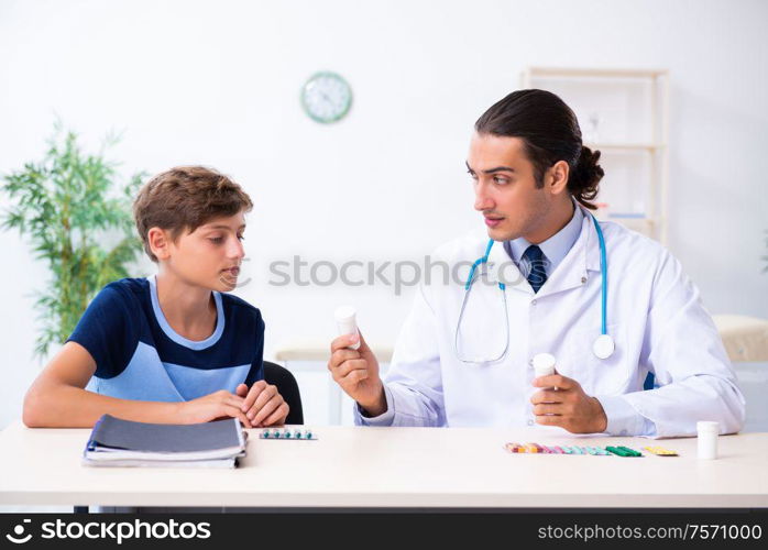 The young male doctor examining boy in the clinic. Young male doctor examining boy in the clinic