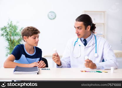 The young male doctor examining boy in the clinic. Young male doctor examining boy in the clinic