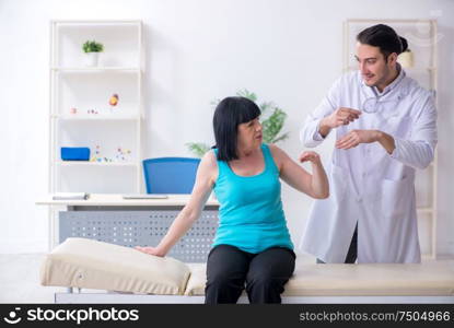 The young male doctor examining old female patient. Young male doctor examining old female patient