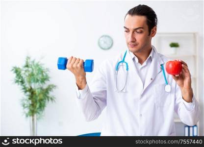 The young male doctor in sport and dieting concept. Young male doctor in sport and dieting concept