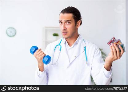 The young male doctor in sport and dieting concept. Young male doctor in sport and dieting concept