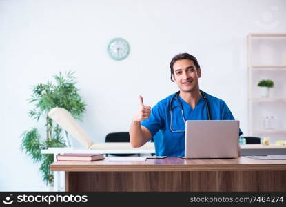 The young male doctor in telehealth concept . Young male doctor in telehealth concept 