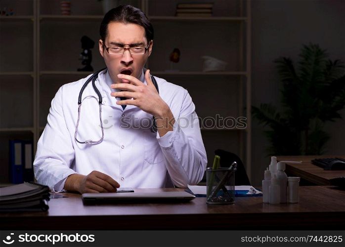 The young male doctor in the hospital at night . Young male doctor in the hospital at night 