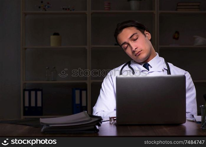 The young male doctor in the hospital at night . Young male doctor in the hospital at night