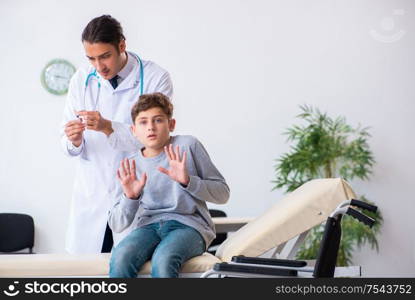 The young male doctor pediatrist and boy in wheel-chair. Young male doctor pediatrist and boy in wheel-chair