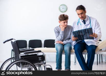 The young male doctor pediatrist and boy in wheel-chair. Young male doctor pediatrist and boy in wheel-chair