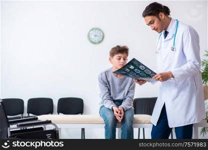 The young male doctor pediatrist and boy in wheel-chair. Young male doctor pediatrist and boy in wheel-chair